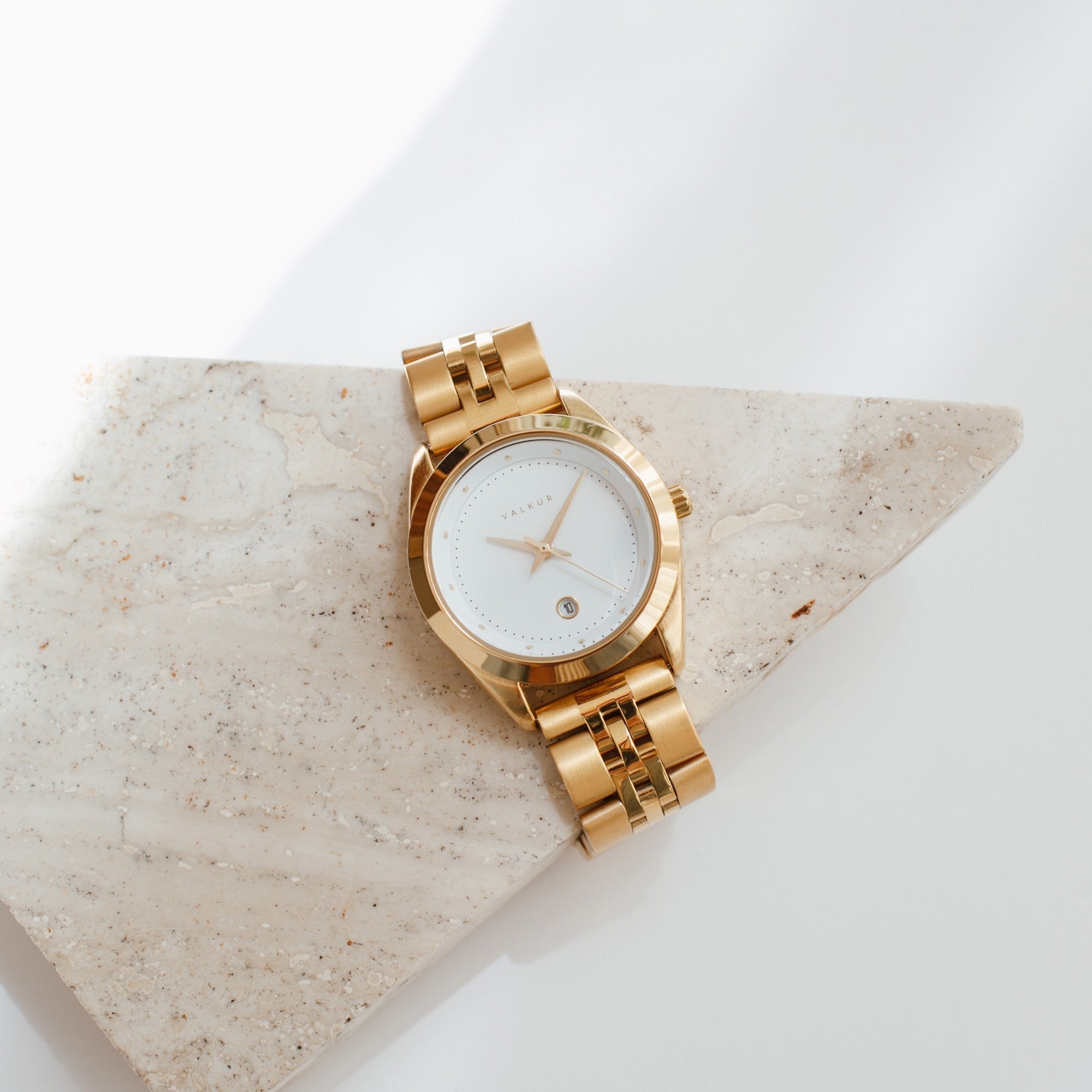 Reloj Valkur para mujeres modelo Lara de acero dorado con bisel dorado y fondo blanco

